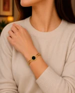 gold bangle with black stone black centrepiece bangle bracelet worn on wrist